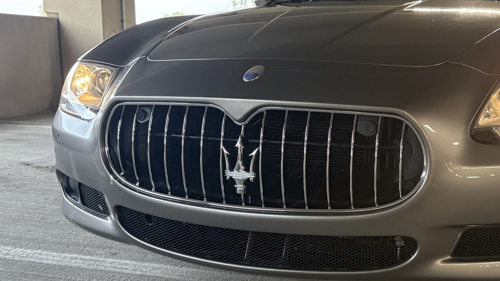 The same Maserati after repair, grille and bumper back to factory finish