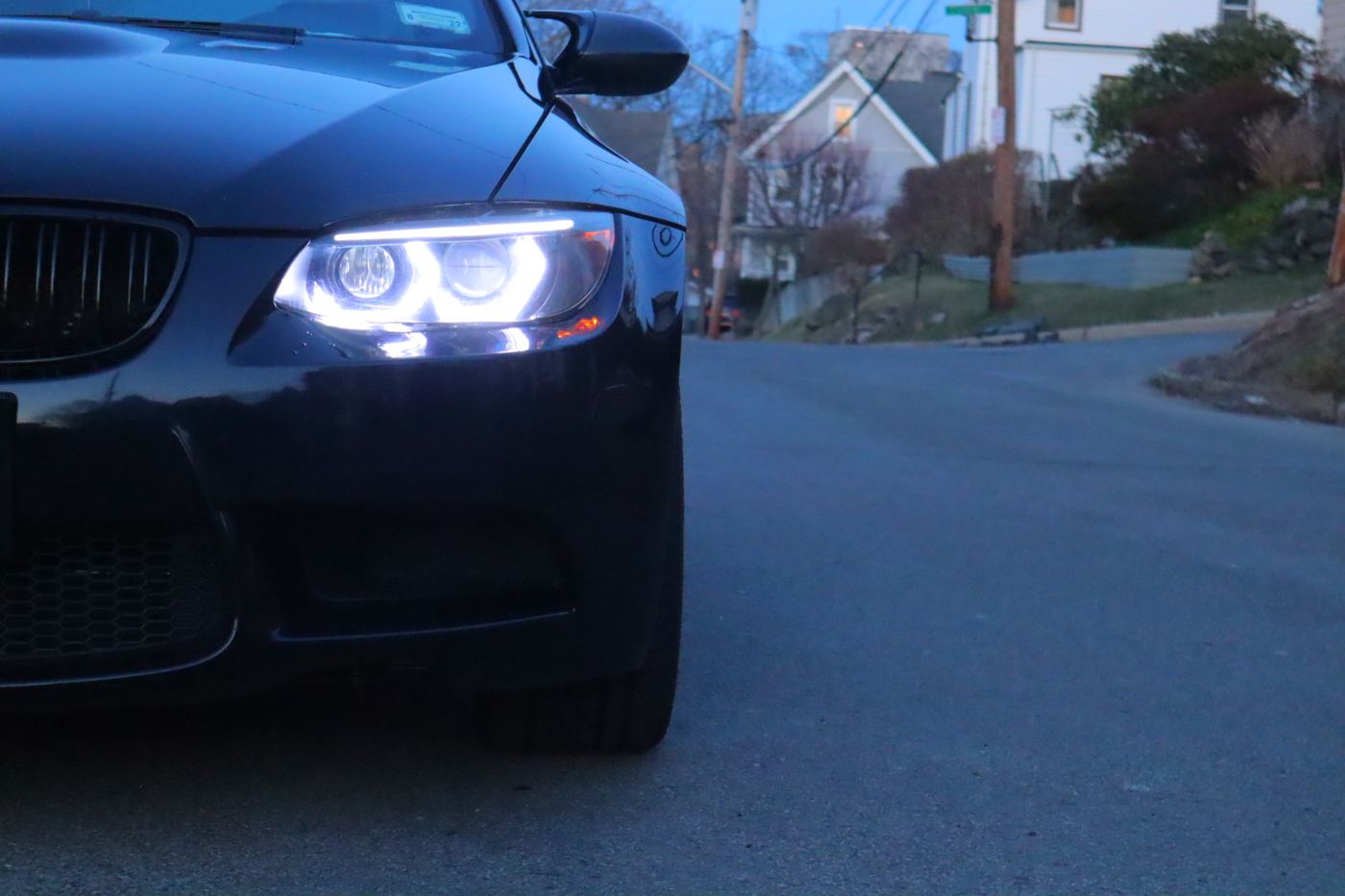 A BMW coupe finished and back on the road at dusk